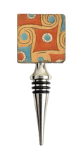 Load image into Gallery viewer, Wine bottle stopper with a colorful geometric pattern in shades of rust, gold, turquoise and ivory.