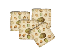 Load image into Gallery viewer, Set of four coasters with a pattern of green and brown eggs on a white background.
