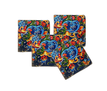 Load image into Gallery viewer, Set of four colorful coasters with floral patterns in shades of blue, green, red and yellow.