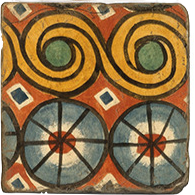 Load image into Gallery viewer, Cork back trivet with swirled geometric pattern in shades of rust, gold, green, blue and ivory.