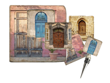 Load image into Gallery viewer, Set of four coasters, cork back trivet and bottle stopper with vintage door designs in shades of lavender, blue, natural wood and stone.
