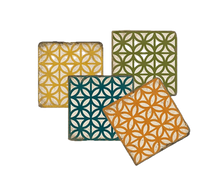 Load image into Gallery viewer, Four square coasters with geometric patterns in yellow, green, blue and orange on a white background.
