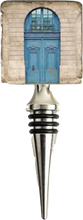 Load image into Gallery viewer, Wine bottle stopper with architectural design featuring a blue door and stone wall.
